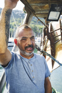 Capitano della barca di pescatori in Sardegna | Most of Italy | Foto Stefano Delìa Ritratto del capitano di una barca da pesca in Sardegna, fotografia di Stefano Delìa per Most of Italy